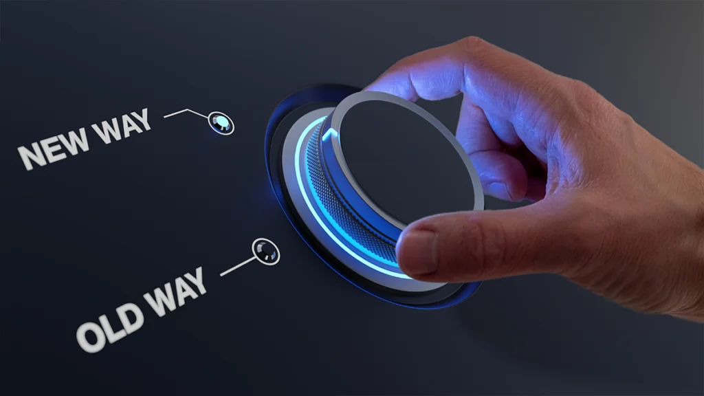 Hand turning knob with choice between old way and new way. Forward thinking, vision and strategy.
